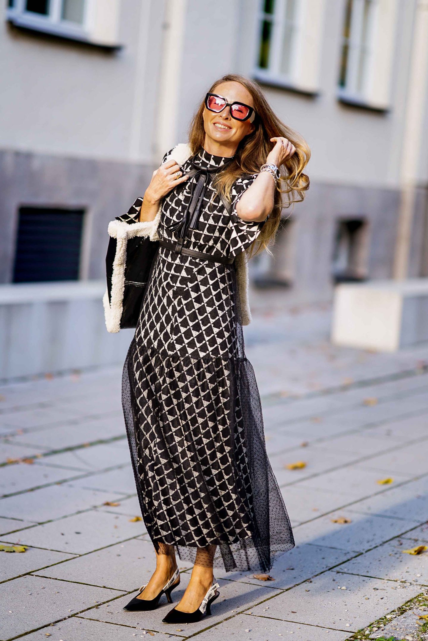 Fashion Bloggerin Nicki Nowicki mit dem Taschen Trend der Saison: Stand Studio Bag aus schwarzem Lack und Fake Fur